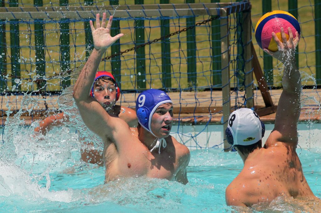 men playing with a ball in swimming pool
